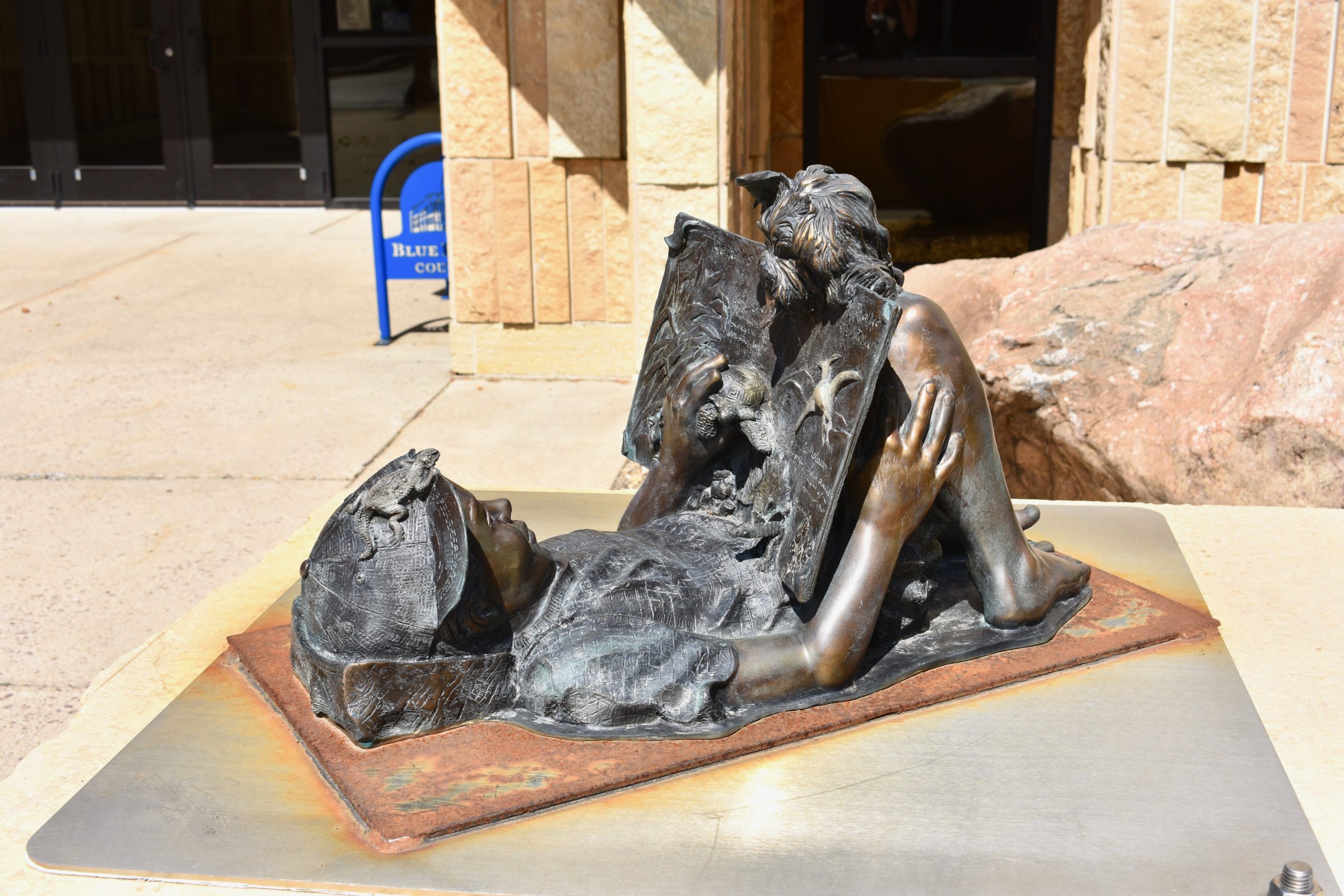 sculpture of a little boy reading