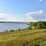 Grassy hill leading to lake