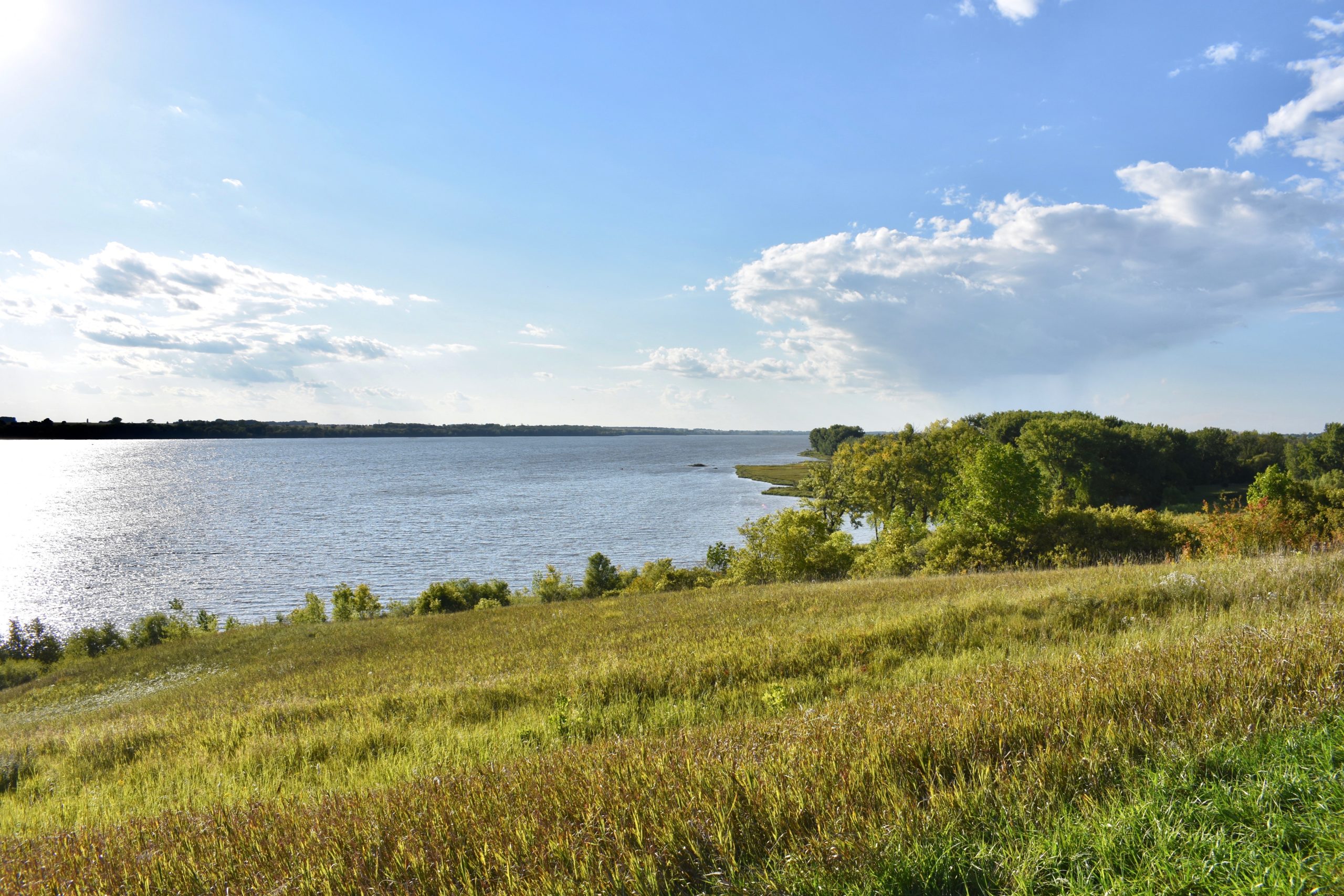 Grassy hill leading to lake