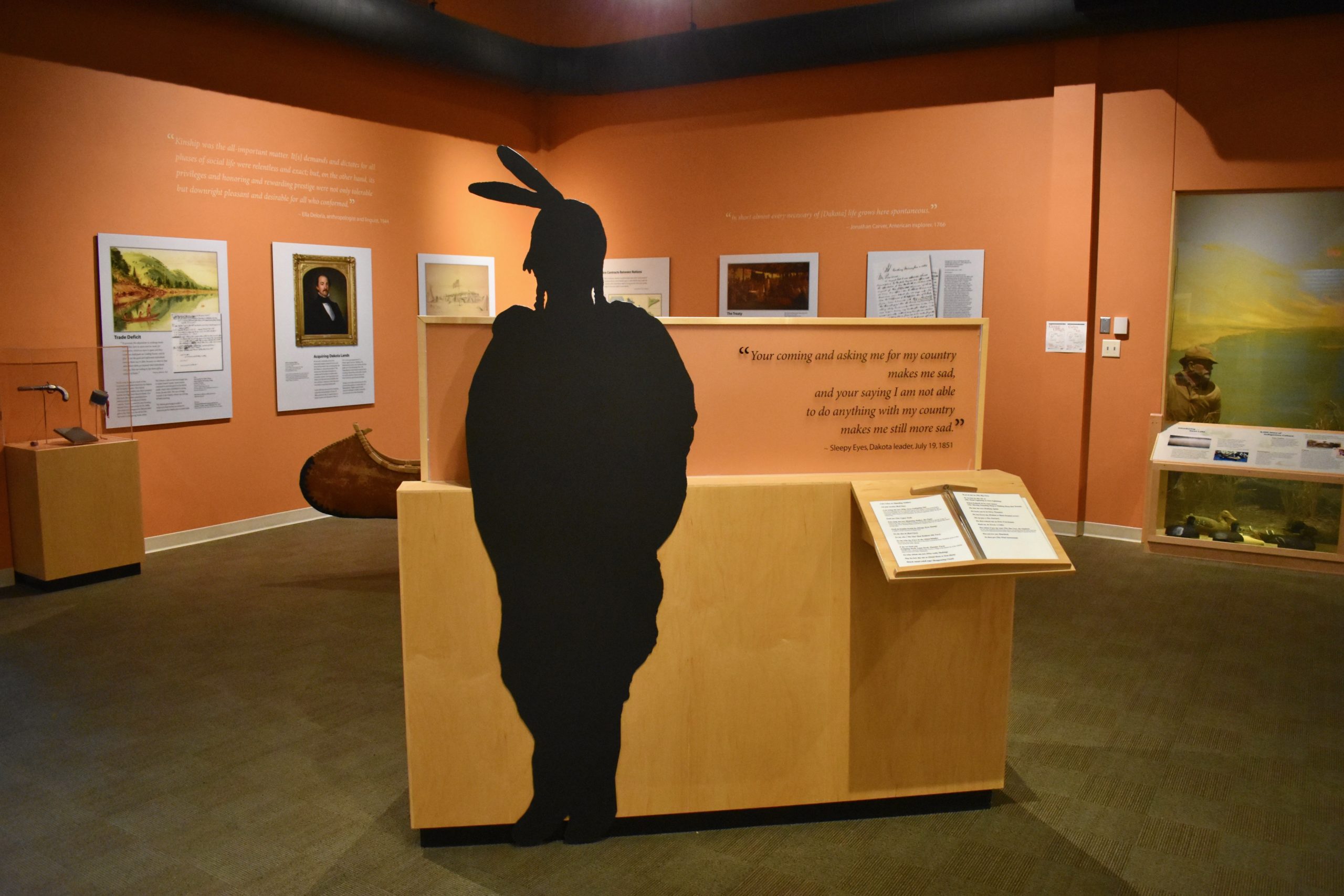 Native American silhouette next to informational displays