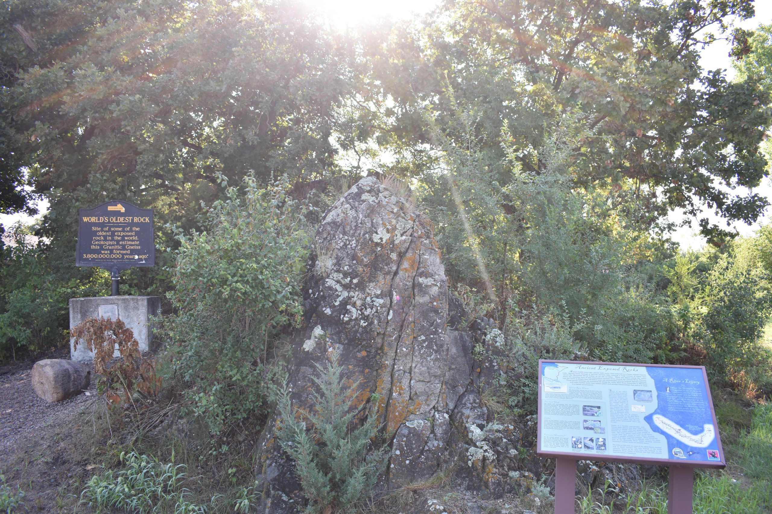 World's oldest rock plaque on left. Ancient Exposed Rocks plaque on right. Rocks in center.