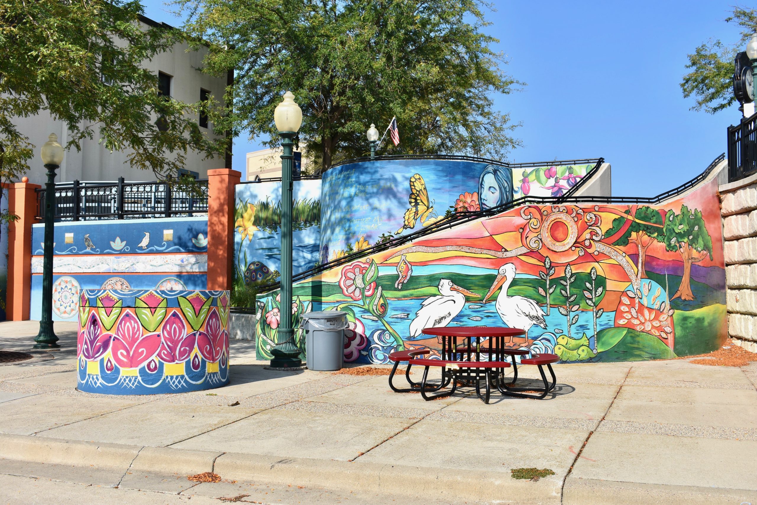 Staircase of colorful murals with picnic table in foreground