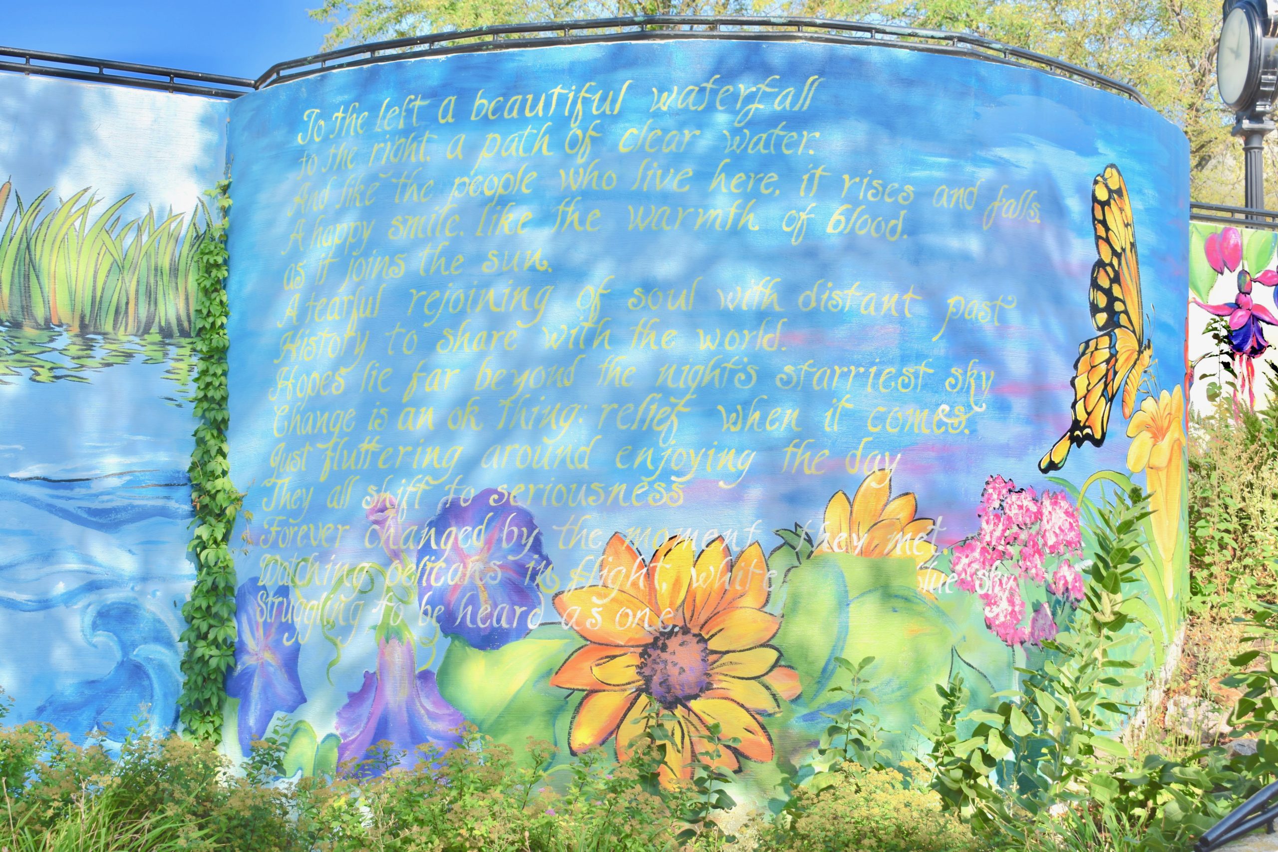 Colorful mural with flowers and a poem