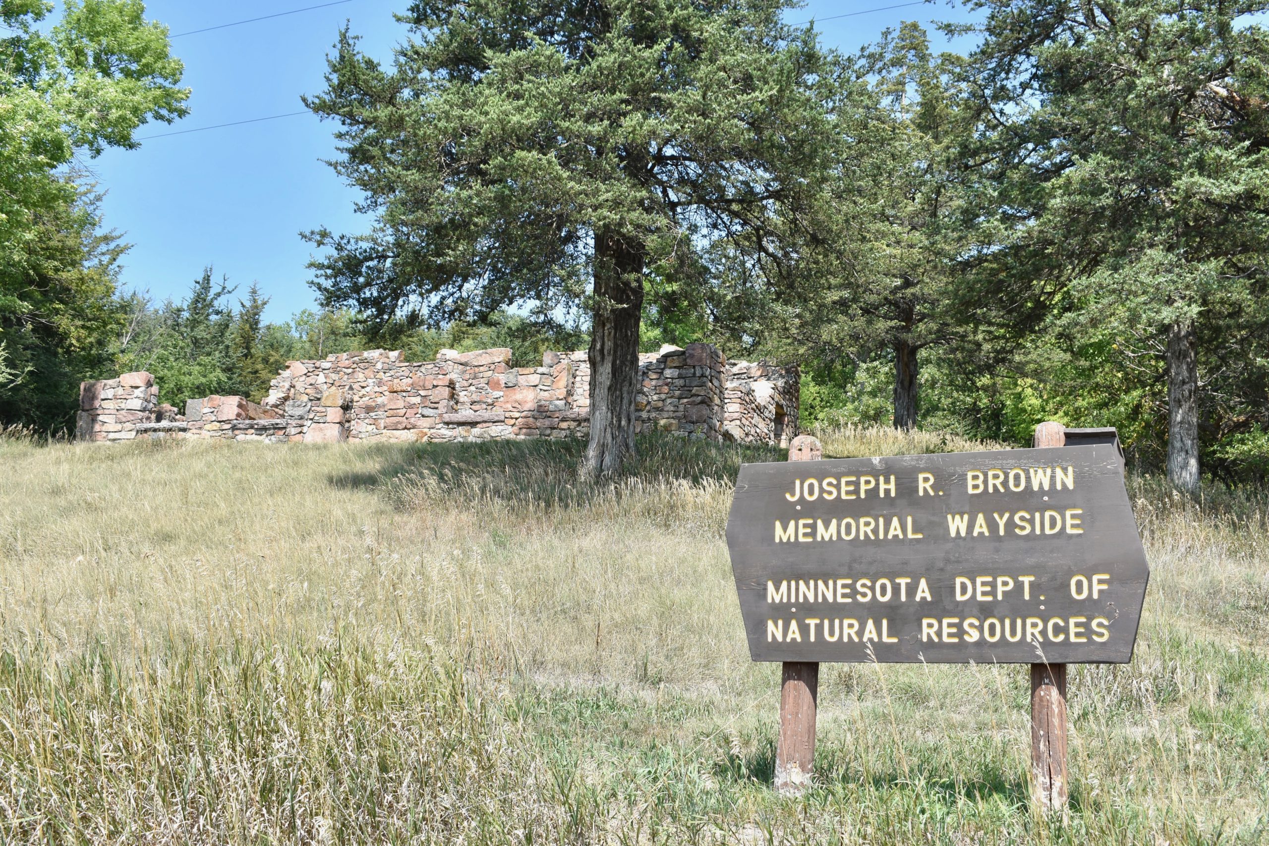 Joseph R. Brown Wayside Memorial sign in foreground. Building in background