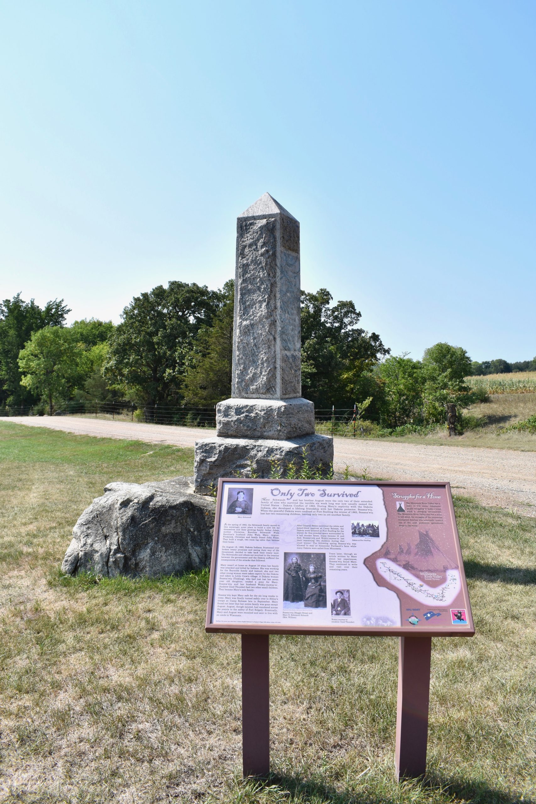 Informational panel in foreground. Memorial in background.
