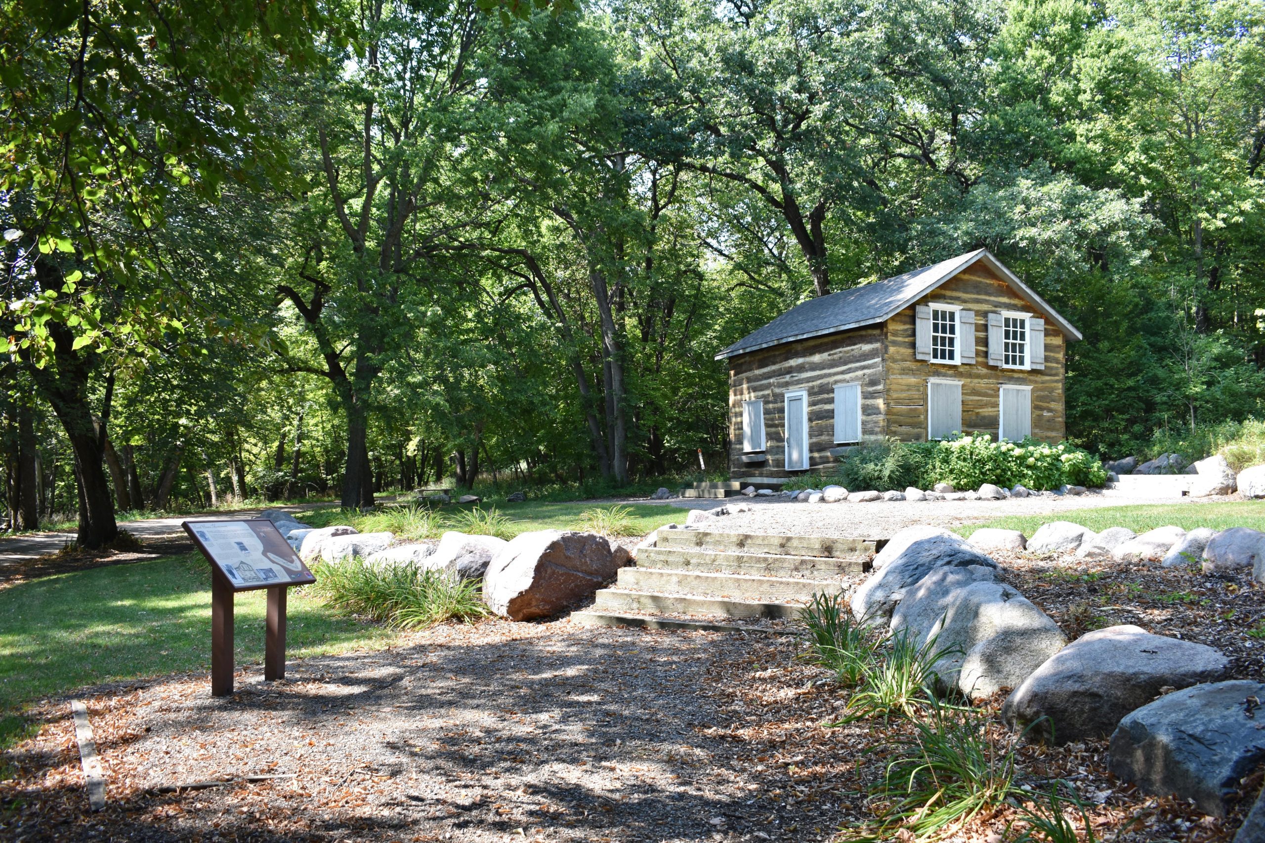 Historic house on right. Information plaques on left