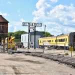 Milwaukee road with yellow train car on right