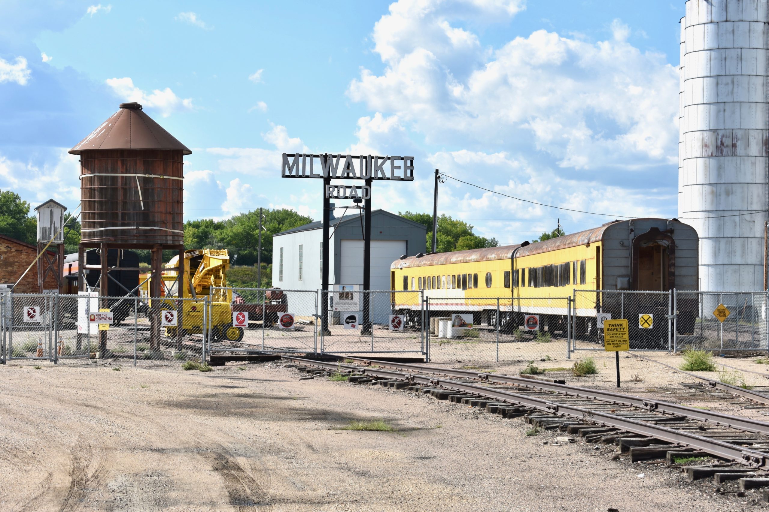 Milwaukee road with yellow train car on right