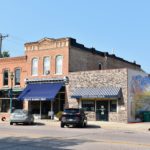 historic district street view. mural on side of brick building.