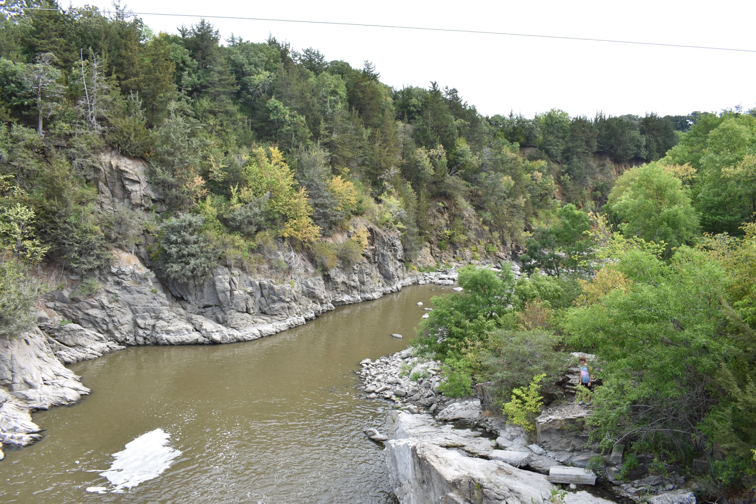 River flowing through rocky cliffs and trees