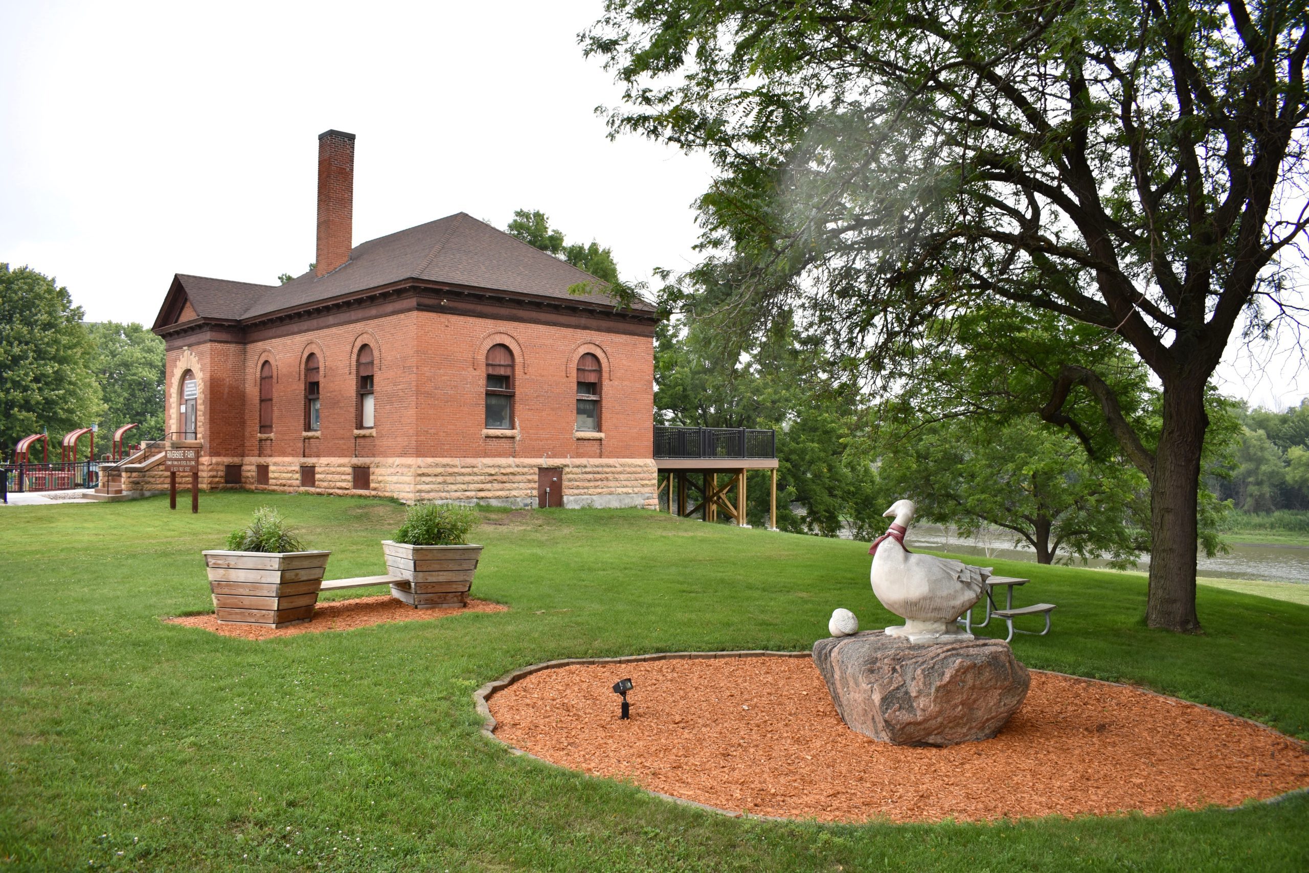 Statue in foreground. Learning Center building exterior in background.
